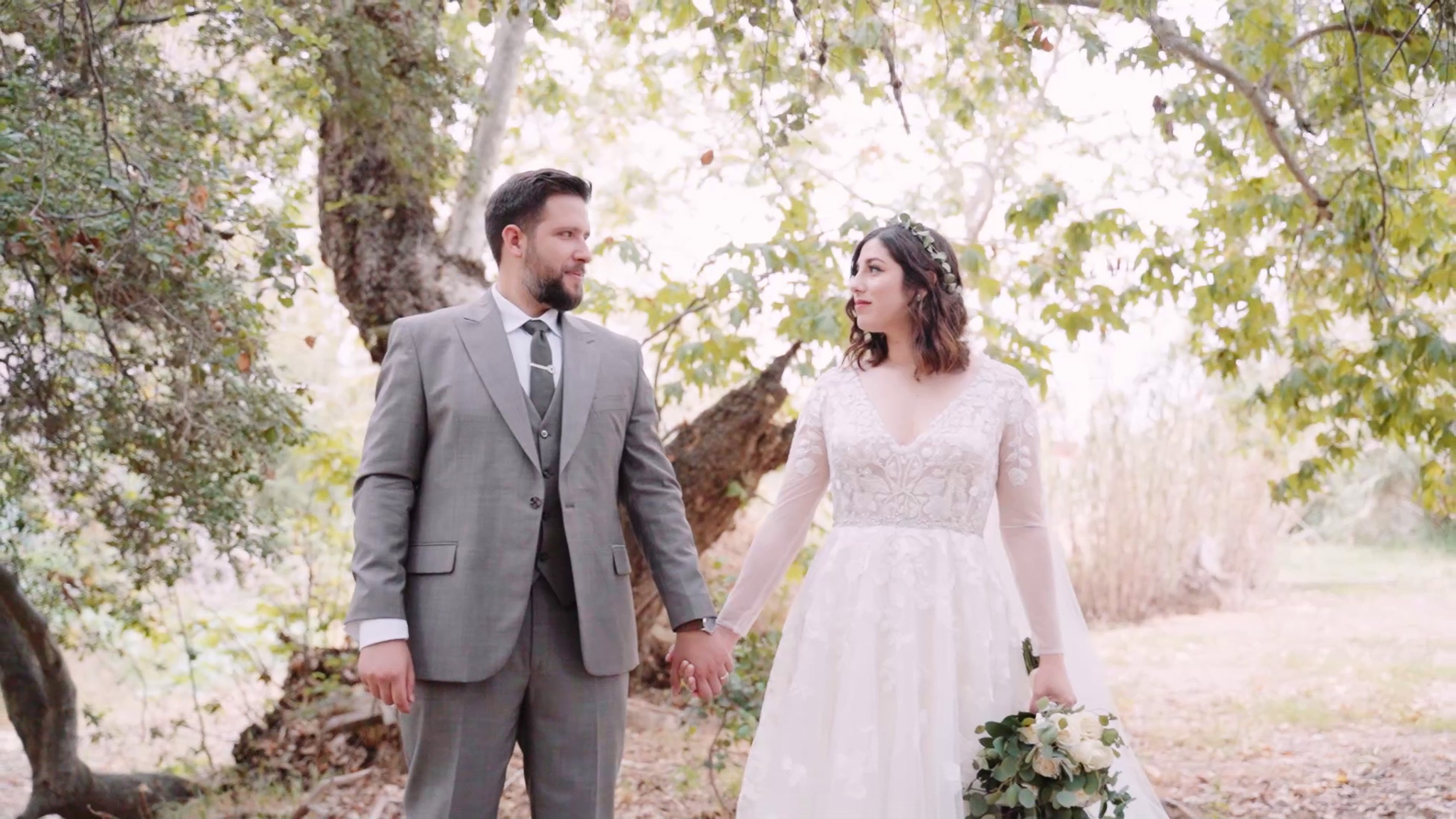 newly married couple looking at each other in the woods